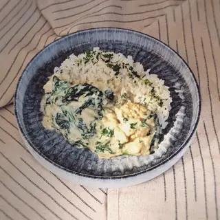 Fish in a creamy sauce with spinach and rice