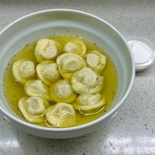 Dumplings with chicken  in broth