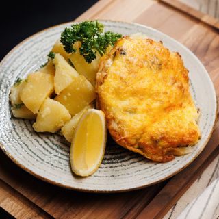 Fish baked with mushrooms and cheese, and potatoes