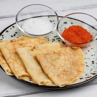 Червона ікра кети власного посолу з тонкими млинцями та сметаною