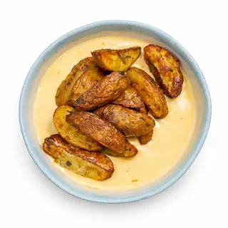 Картопля печена з сирним соусом (250г)