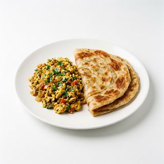 Huevos revueltos con cebolla y tomate + 2 paratha normal
