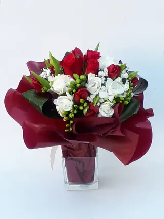 Bouquet fresie e rosette rosse.