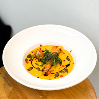 Pumpkin cream soup with Brussels sprouts and shrimp