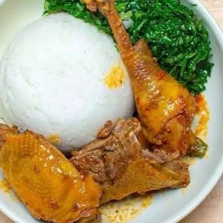White ugali served with kuku kienyeji and sukuma mixed with spinach 