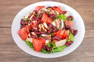 Chicken on the grill with red beans and tomatoes 