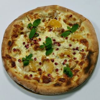 Pizza with turkey and tangerines