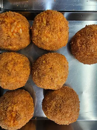 Arancino bolognese con piselli e cotto
