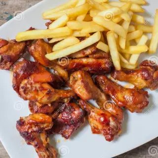 Barbeque chicken wings served with chips