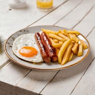 Chips, Spanish omelette and a pair of smoked chicken sausages served and a free soda