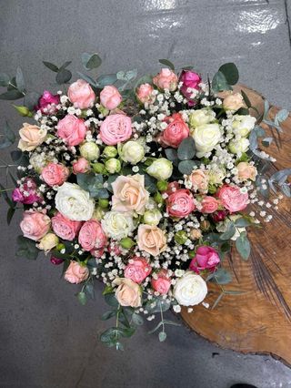 Pink and white roses with gypsophila in heart shaped box