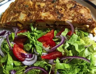 Tortilla de jamón con ensalada y papas