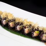 Uramaki black salmon croc roll