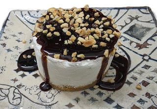 Cheesecake con topping al cioccolato e granella di nocciole