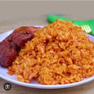 Home made  jollof rice  along with plantain served with beef