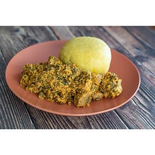 Egusi soup and eba with meat and Kpomo
