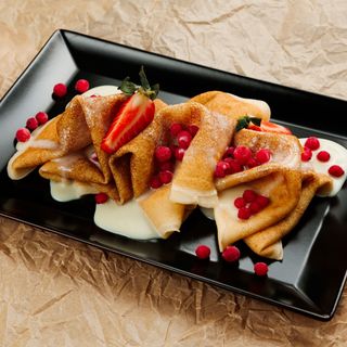 Pancakes with condensed milk and red currants