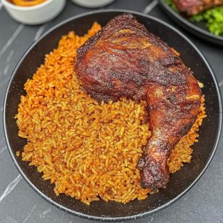 Jollof rice and deep fried chicken in Nigerian sauce 