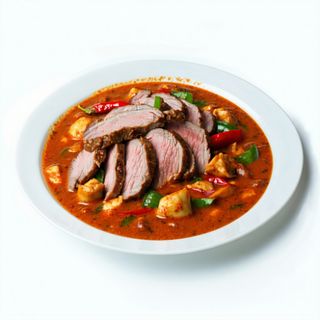 Pato Flameado Con Curry Y Coco