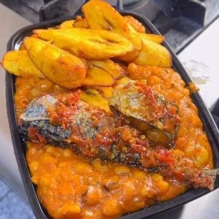 Nigerian beans porridge plantains and titus fish with drinking water 