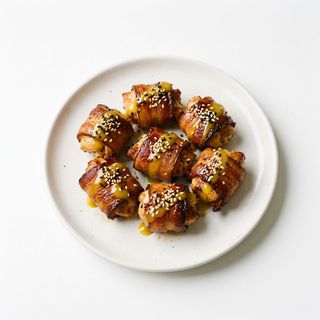 Запечени пилешки хапки в бекон - 200г