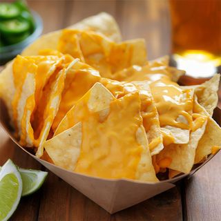 Nachos Mexicanos Con queso cheddar, guacamole, jalapeños y salsa agria.