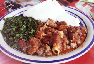 Wet Fried Goat's Meat With Posho And Green Vegetables