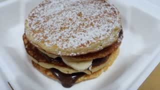 Pancakes with Bananas and  Chocolate sauce.