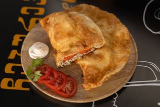 Cheburek with beef and tomatoes.