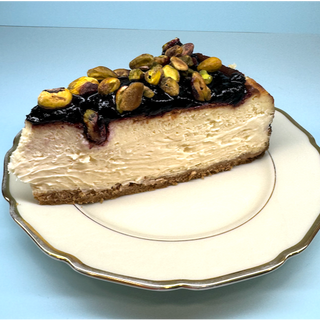NY CHEESECAKE ARÁNDANOS Y PISTACHOS PORCIÓN