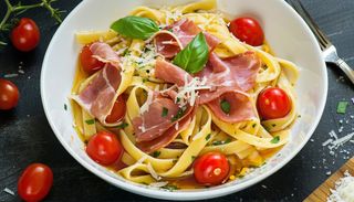 Świeży makaron con speck e pomodorini