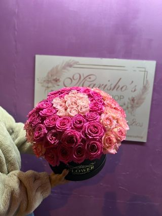 Light and dark pink roses in a box
