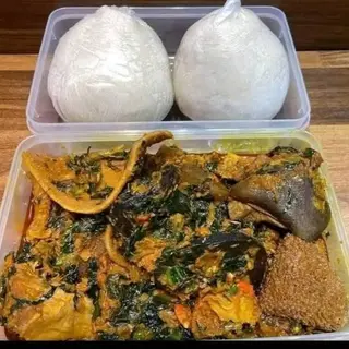White Eba served with assorted goatmeat mixed with eforiro vegetables 