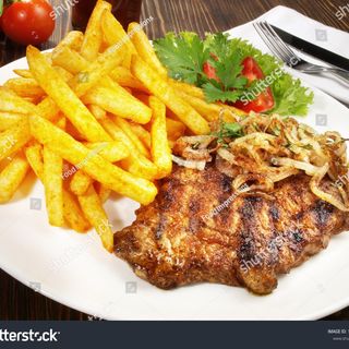 Pork steak with chips and salad