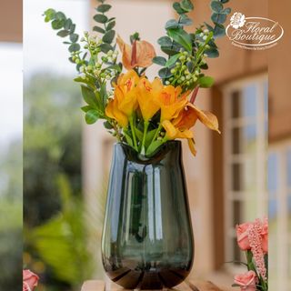 Special long green vase with artificial  flowers