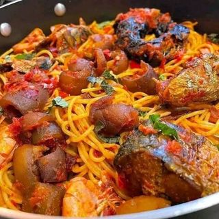 Jollof sphaghetti served with pomo and titus fish 