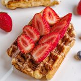 Belgian waffle with milk chocolate and strawberry 