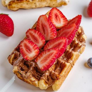 Belgian waffle with milk chocolate and strawberry 