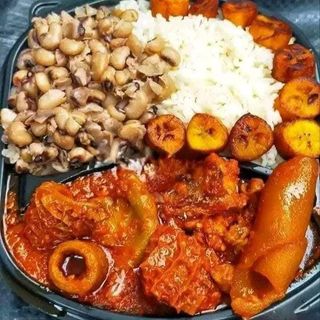 Nigerian beans mixed with white rice served with plantains and assorted