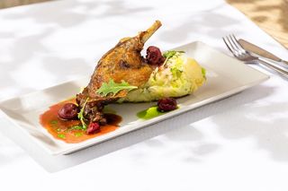 Pulpă raţă confit cu varză roşie cu stafide si nucă si sos demi-glace cu fructe roşii 