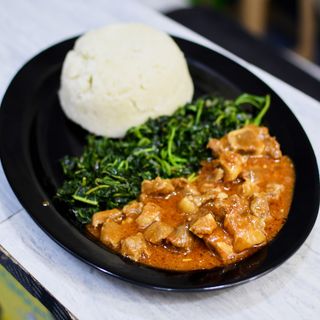 Beef stew with steamed vegetables and Ugali 