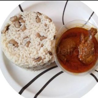Rice and beans served with stew and protein