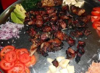 1/2 kg  pork without fat skin served with pressed matooke and Cassava 