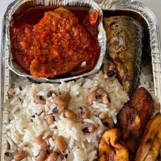 White rice mixed with beans, beef, tilapia fish and plantains 