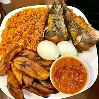 Plantains, Jollof rice, 2 titus, 2 boiled eggs with sauce on the side
