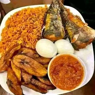 Plantains, Jollof rice, 2 titus, 2 boiled eggs with sauce on the side