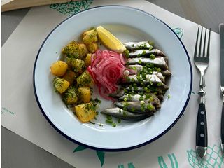 Тюлька з печеною картоплею, зеленою цибулькою і пряним маслом (250g)