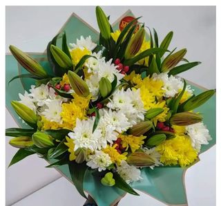 Tropical delight: A blend of yellow and white mums, tiger lilies and  berry