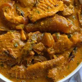 Ogbono mixed with shaki, pomo and chicken