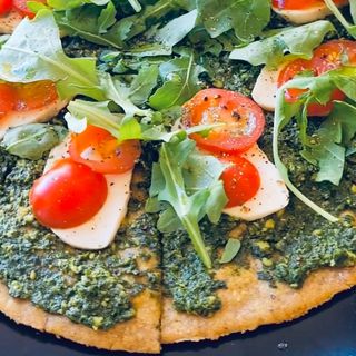 Flatbread with Basil Pesto, Tomatoes and homemade cashew mozzarella 